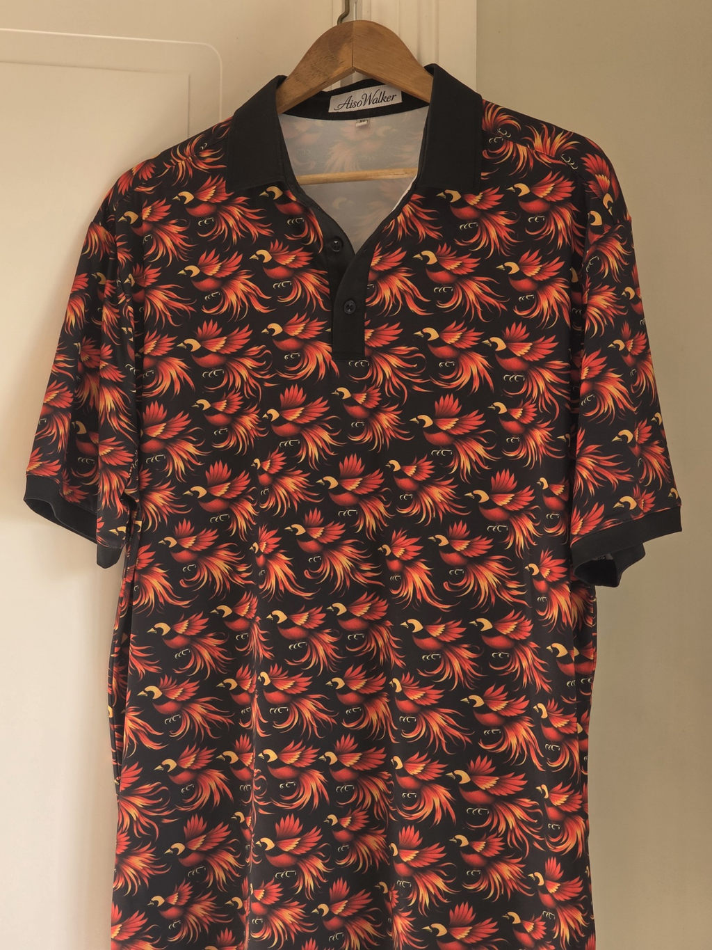 AisoWalker Bird of Paradise polo shirt on hanger showing full print detail and AisoWalker label